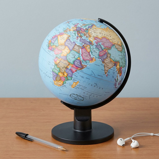 A PDP image showing the specific Replogle 6-inch blue ocean desk globe in miniature scale next to a standard writing pen for immediate size reference in a clean office setting.