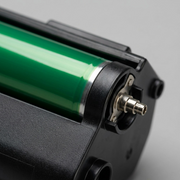 Extreme close-up of the Xerox 101R00602 drum cartridge, showing the green drum surface and metal connector gear.