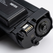 Macro close-up of Xerox 006R04401 toner cartridge chip contacts and drive gear.
