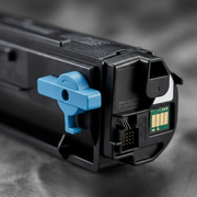 Macro photograph of the blue cyan and black mechanisms on the end of the Xerox toner cartridge against a blurred background.