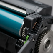 Macro close-up of Xerox imaging unit electrical contacts, drum surface, and metal gears.