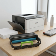 A lifestyle photo showing the distinct Xerox 013R00690 black imaging unit (green handle, blue drum visible) resting with printer gears on a clean desk, ready to be installed in a printer. The packaging from the reference image is not present.