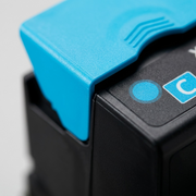 Extreme macro shot of texture and seam detail on a high-capacity cyan Xerox toner cartridge.