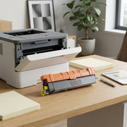 A clean, photo of the compatible TN229XLY yellow toner cartridge from image_0.png, resting next to a white laser printer inside a modern home office.