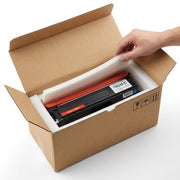 Close-up of a well-padded shipping box opening to reveal the secure TN339 C toner cartridge.