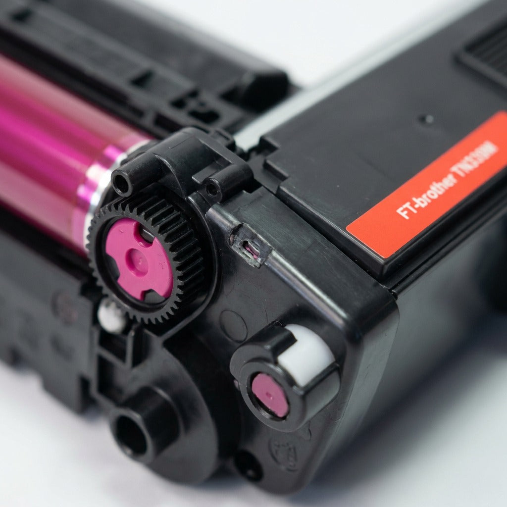 Macro view of the magenta gear mechanism and drum surface on the recycled Brother TN339M toner cartridge.
