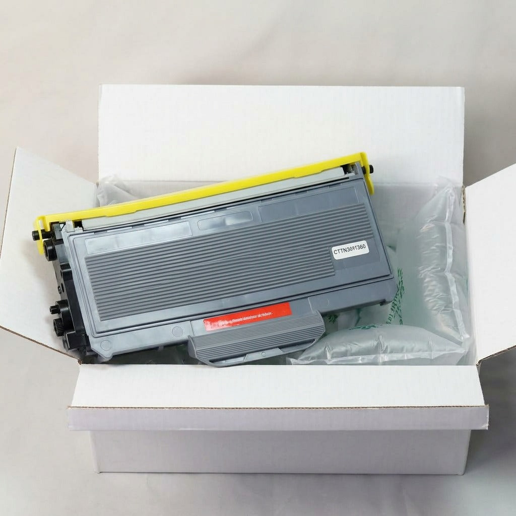 A photo-realistic image of the unboxed toner cartridge next to protective air cushions.