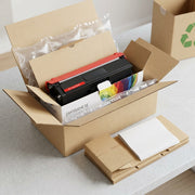 Premium unboxing scene showing the specific toner and its box protected by clean air pillows and mailer.
