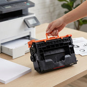 A high-quality product photo of a high-yield compatible toner cartridge in an office setting, ready for installation.