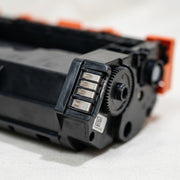 Extreme close-up of the Balloon Brand W1470X toner cartridge's fine plastic gear and drive connection point, reducing purchase hesitation.