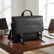 A lifestyle photo showing the Bugatti The Rolling Stones messenger bag on an desk.