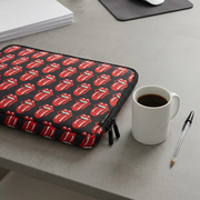 Bugatti laptop sleeve on desk beside coffee mug and pen for size reference.