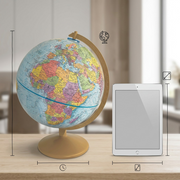 A scale reference image showing the Replogle Explorer desk globe next to a standard tablet and a coffee mug.