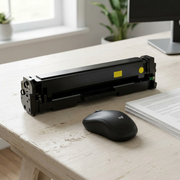 Elevate Imaging HP CF402A toner cartridge at a home office desk, beside a wireless mouse and paper stack.