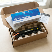 A premium, realistic unboxing scene showing the Elevate Imaging CF402A cartridge and its retail box carefully protected by neutral custom pulp molding in a shipping container.