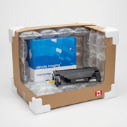 Alt text: An Elevate Imaging HP CE505A toner cartridge in its retail box is shown within sturdy cardboard shipping packaging with air pillows and protective corners, illustrating safe delivery.