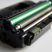 Extreme close-up of a toner cartridge's complex internal components and electrical chip contacts.
