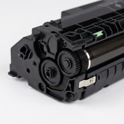 Macro detail photography highlights the gear train and mechanical components of the Elevate toner cartridge.
