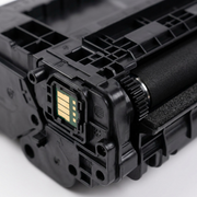 Extreme macro view of the complex black plastic molding and electronic chip contacts on the HP CF237X compatible toner cartridge.