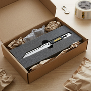 An unboxing scene shows the OLFA graphics knife inside its cardboard box with protective foam.