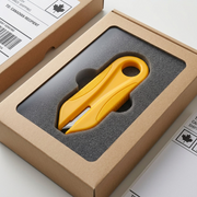 Yellow safety cutter sits securely in custom foam packaging, highlighting safe and damage-free delivery for Canadian customers.
