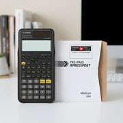 Black Casio FX-300ESPLS2 scientific calculator shown beside a Canada Post Xpresspost envelope for scale.