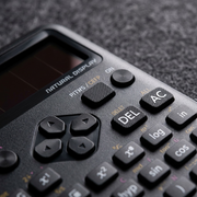 Macro detail of a Casio FX-300ESPLS2 scientific calculator showing textured buttons and display.