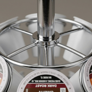A macro photo focuses on a chrome joint of the Keurig pod carousel, highlighting the smooth metal and fine print quality on the k-cups.