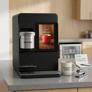 Commercial coffee machine scale, shown next to a ceramic mug, standard stapler, and notepad on a desk.