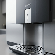 Macro photo detailing the Keurig Eccellenza Touch brewer's metal textures, spout, and logo.