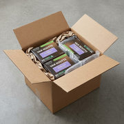 A close-up photograph shows the Van Houtte boxes cushioned with air pillows inside a sturdy shipping box.