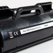 Extreme macro photo of the 'Non-OEM Replacement for: T644' label and plastic texture on a toner cartridge.