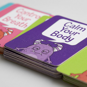 Macro photo showing the thick cardstock, clean edges, and printed details of the fdmt Anger Management Cards.