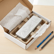 A detailed overhead photograph of a metal tin of 6 Mars Lumograph drafting pencils, protected in open shipping packaging.
