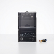 A photo of the Canon PCPL-CP400 paper cassette next to a standard AA battery.