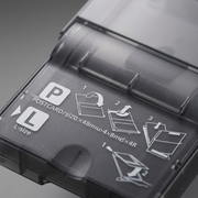 A micro close-up of the paper cassette's user interface, highlighting specific instructional guides.