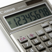 Macro detail of the Canon LS-63TG calculator showing the 8-digit LCD screen and tactile keypad.