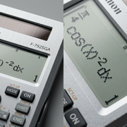 Macro detail of F-792SGA calculator showing solar panel, brushed metal finish, and 4-line LCD.