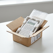 Canon F-605G scientific calculator securely packed in a shipping box with protective bubble wrap.