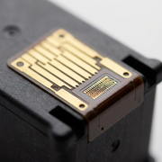 Macro photo of gold-plated electrical contacts on Canon CL-244 ink cartridge.