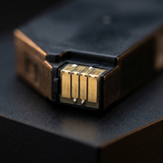 Extreme macro photo showing the precision contacts of the Canon PGI-280XL Black ink cartridge, emphasizing clear, well-defined golden metal connection points.