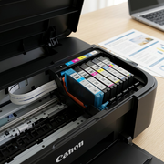 A close-up photograph of an uncapped Canon CLI-281XL cyan ink cartridge installed in a Canon PIXMA printer printhead.