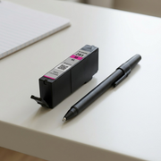 A photo of the Canon 281XL Magenta ink cartridge next to a standard ballpoint pen for scale.