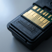 Macro close-up of Canon PG-210 XL ink cartridge gold contacts and high-density nozzle plate.