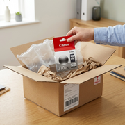 Unboxing Canon PG-210XL black ink: protective air pillows in an eco-mailer with a shipping label.