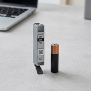 Scale reference photo for Canon CLI-281 Black ink, shown at true size next to an AA battery.