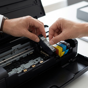 A close-up photograph of a Canon CLI-281 Black ink tank installed within a Canon PIXMA printer ink carriage.