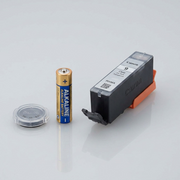 An image showing the Canon PGI-9 Clear Ink Tank sitting next to a standard AA battery.