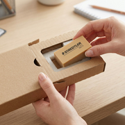 An unboxing scene shows a protective card sleeve around the STAEDTLER Mars 0925-11-04 eraser.