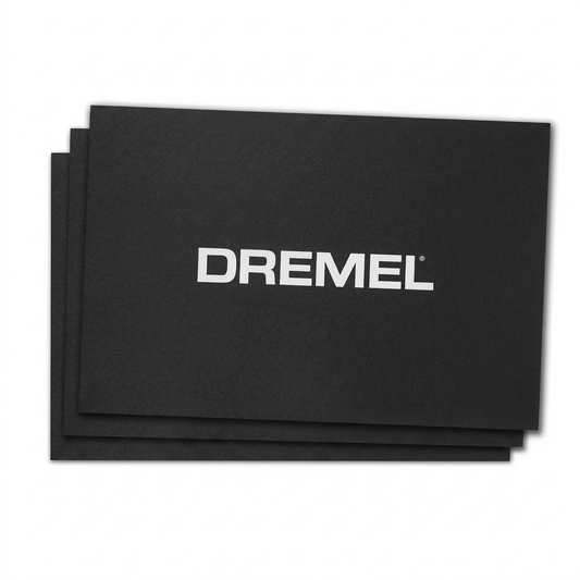 A crisp hero shot of the Dremel 3D40 Build Sheet 3-pack, featuring three black textured sheets stacked to show the edges, with the centered "DREMEL" logo visible.